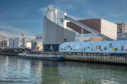 vue depuis la Seine de la centrale à béton Heidelberg Materials nouvellement moderinsée sur le port de Clichy. On y voit une barge à quai. - Agrandir l'image, fenêtre modale